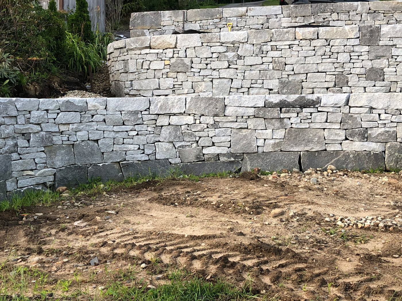 Double granite retaining wall under construction